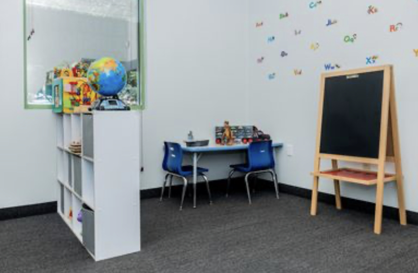 Speech and Language Room at Little Dreamers PPEC with alphabet wall